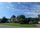 Beautiful two-story home with stone accents, a well-kept lawn, and lush trees against a blue sky at 5807 Brookstone Nw Walk, Acworth, GA 30101