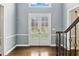 Inviting foyer with decorative glass doors, hardwood floors, and detailed trim work at 5807 Brookstone Nw Walk, Acworth, GA 30101