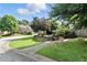 Well manicured front yard with a landscaped stone retaining wall and walkway at 5807 Brookstone Nw Walk, Acworth, GA 30101
