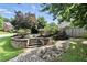 Landscaped front yard with stone retaining wall and brick walkway leading to the house at 5807 Brookstone Nw Walk, Acworth, GA 30101