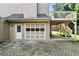Garage exterior featuring a door, glass panel garage door, and deck stairs at 5807 Brookstone Nw Walk, Acworth, GA 30101
