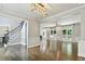 Spacious living room with hardwood floors, large windows, and stylish light fixtures at 5807 Brookstone Nw Walk, Acworth, GA 30101