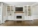 Cozy living room featuring a fireplace with custom built-ins and hardwood flooring at 5807 Brookstone Nw Walk, Acworth, GA 30101