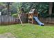 Backyard view of the wooden playset, including swings, climbing area, and slide at 5807 Brookstone Nw Walk, Acworth, GA 30101