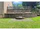 Large stone retaining wall with garden area and a small seating area at 5807 Brookstone Nw Walk, Acworth, GA 30101