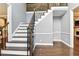 Beautiful staircase featuring dark wood steps, white risers, and decorative iron railings at 5807 Brookstone Nw Walk, Acworth, GA 30101