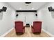 A theater room with two red recliners, speakers, and a ceiling fan at 5807 Brookstone Nw Walk, Acworth, GA 30101