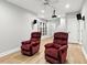 A theater room with two red recliners, a ceiling fan, and speakers at 5807 Brookstone Nw Walk, Acworth, GA 30101