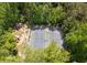 Aerial view of the community tennis court and playground surrounded by lush trees at 845 Melbourne Trl, Alpharetta, GA 30009