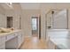 Bright bathroom features tile flooring, a tub shower with glass door, and vanity with drawers at 845 Melbourne Trl, Alpharetta, GA 30009