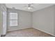 Simple bedroom features neutral walls, carpet, a window, and a closet at 845 Melbourne Trl, Alpharetta, GA 30009
