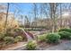 A bridge in a park-like setting near a community playground and tennis courts at 845 Melbourne Trl, Alpharetta, GA 30009