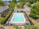 Aerial view of the community pool showcasing ample lounge chairs and a bath house at 845 Melbourne Trl, Alpharetta, GA 30009