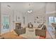 Cozy living room with fireplace, built-in shelving, and access to the backyard at 845 Melbourne Trl, Alpharetta, GA 30009