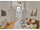 Open-concept living room with high ceilings, hardwood floors, and plenty of natural light at 845 Melbourne Trl, Alpharetta, GA 30009