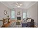 Inviting living room boasts a fireplace, hardwood floors, and a gray sectional sofa at 845 Melbourne Trl, Alpharetta, GA 30009