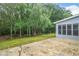 View of a concrete patio leading to the backyard and bordering a sunroom at 845 Melbourne Trl, Alpharetta, GA 30009
