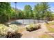 Well-maintained tennis courts surrounded by lush greenery with beautiful landscaping at 845 Melbourne Trl, Alpharetta, GA 30009