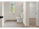 Bathroom with toilet, shower, closet, and tile floors at 2135 Huntington Dr, Loganville, GA 30052