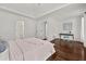 This bright bedroom features a vaulted ceiling, wood floors, and access to an ensuite bathroom and walk-in closet at 2135 Huntington Dr, Loganville, GA 30052