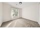 A bright bedroom features a window with natural light and neutral carpet at 2135 Huntington Dr, Loganville, GA 30052