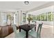 Charming dining area with light-colored chairs and access to a sunroom at 2135 Huntington Dr, Loganville, GA 30052