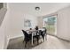 Elegant dining room with modern table, stylish chairs, and a large window view at 2135 Huntington Dr, Loganville, GA 30052
