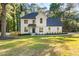 Beautifully renovated two-story home with a lush lawn and modern farmhouse design at 2135 Huntington Dr, Loganville, GA 30052