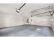 Spacious two-car garage with gray painted floor and high ceilings at 2135 Huntington Dr, Loganville, GA 30052
