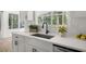Bright kitchen featuring white countertops, modern fixtures, and a serene view of the backyard at 2135 Huntington Dr, Loganville, GA 30052