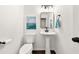 Modern powder room with a pedestal sink, sleek fixtures, and contemporary decor at 2135 Huntington Dr, Loganville, GA 30052
