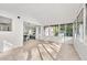 Bright sunroom with large windows and neutral tile flooring, adjacent to the dining area at 2135 Huntington Dr, Loganville, GA 30052