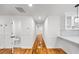Hallway leads to other rooms, including an updated bathroom and kitchen with white cabinetry at 2798 Hutchins Rd, Lawrenceville, GA 30044