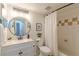 Bright bathroom featuring a white vanity, framed round mirror, and a shower/tub combo with neutral tile at 3135 Seven Pines Ct # 8, Atlanta, GA 30339