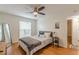 Bright bedroom with ceiling fan, wooden floors, neutral walls, and ensuite access to bathroom at 3135 Seven Pines Ct # 8, Atlanta, GA 30339