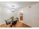 Dining area with a modern light fixture, wood floors, and access to the kitchen at 3135 Seven Pines Ct # 8, Atlanta, GA 30339
