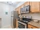 Kitchen featuring stainless steel appliances, granite countertops, and wood cabinets at 3135 Seven Pines Ct # 8, Atlanta, GA 30339