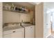 Convenient laundry room featuring a modern Maytag washer and dryer, as well as ample shelving for storage solutions at 3135 Seven Pines Ct # 8, Atlanta, GA 30339