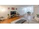 Living room with an open layout, hardwood floors, a gray sofa, and access to the dining area at 3135 Seven Pines Ct # 8, Atlanta, GA 30339