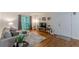 Comfortable living room with hardwood floors, gray sofa, and sliding glass doors to a balcony at 3135 Seven Pines Ct # 8, Atlanta, GA 30339