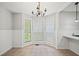 Bright breakfast nook with wainscoting, tiled floors, and large windows overlooking a view at 94 Park W Ave, Dallas, GA 30157