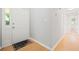 Bright foyer featuring hardwood floors, a white front door, and neutral walls and trim at 94 Park W Ave, Dallas, GA 30157