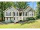 Charming split-level home with green siding, black shutters, and a inviting front entrance with a stairway at 94 Park W Ave, Dallas, GA 30157