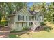 Charming split-level home with green siding, black shutters, and a side two-car garage with a driveway at 94 Park W Ave, Dallas, GA 30157
