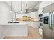 Modern kitchen featuring white cabinetry, stainless steel appliances, and a breakfast bar at 94 Park W Ave, Dallas, GA 30157