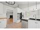Open kitchen view with stainless appliances, stone countertops and tile flooring at 94 Park W Ave, Dallas, GA 30157