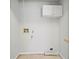 Minimalist laundry room includes white cabinets and connections for appliances at 94 Park W Ave, Dallas, GA 30157