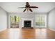 Bright living room with vaulted ceiling, a fireplace, and sliding glass doors to the outdoor space at 94 Park W Ave, Dallas, GA 30157