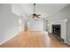 Open-concept living room with vaulted ceilings, hardwood floors, and a brick fireplace at 94 Park W Ave, Dallas, GA 30157