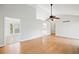 Spacious living room with vaulted ceilings, wood floors, and natural light through an adjoining doorway at 94 Park W Ave, Dallas, GA 30157
